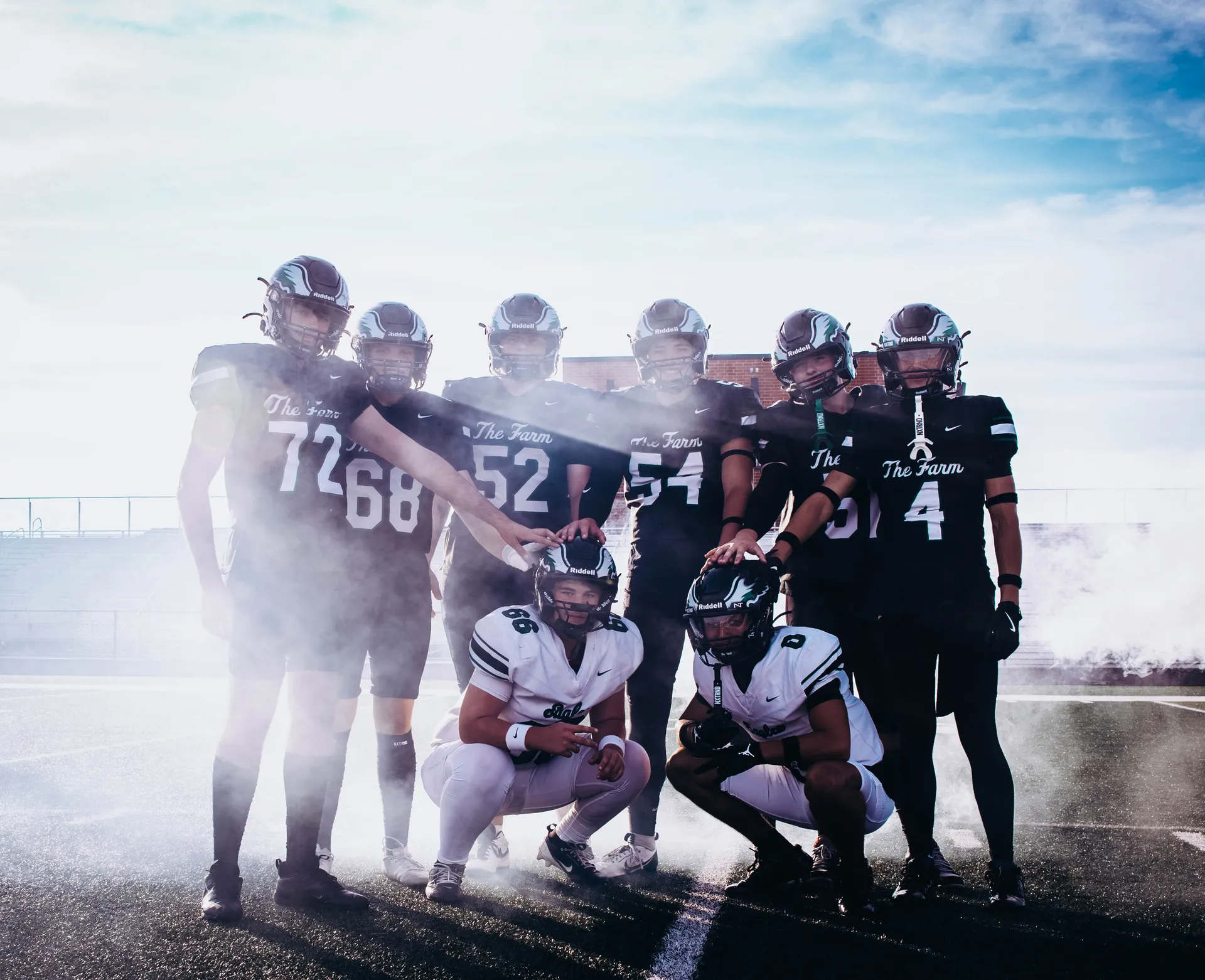 Orchard Farm seniors pose in the smoke, including Jesse Omohundro, Chris Boschert, Eli Krill, Blake Hollrah, John Boehmer, Patrick Stifel, Mikey Lewis and Brendan Hudzik