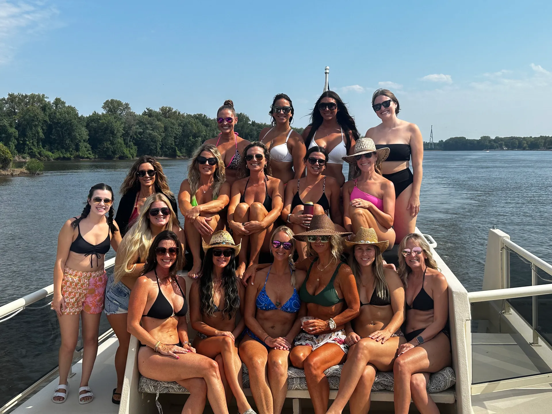 The River Rats girls gathered on the bow of a boat on the Mississippi River