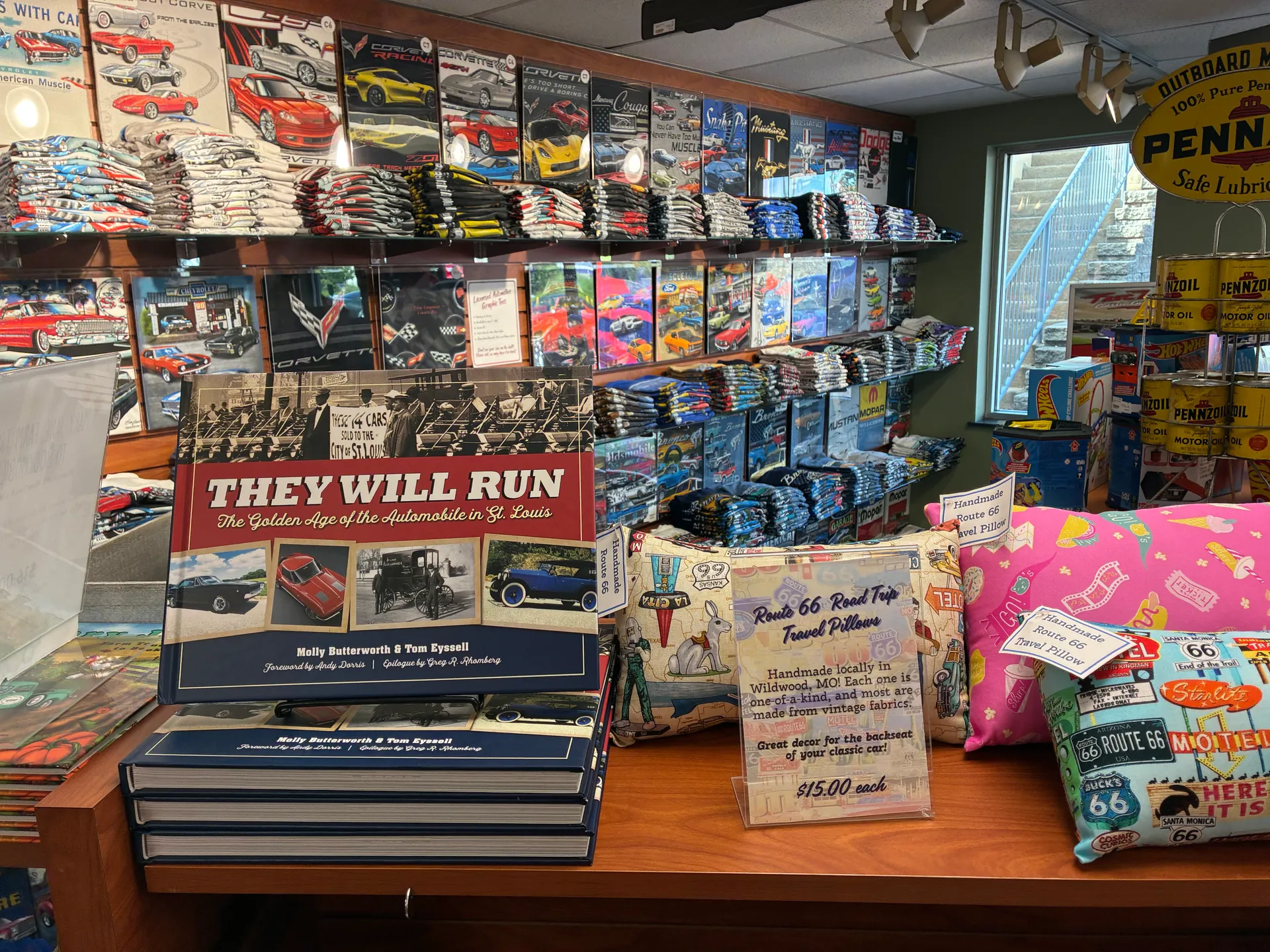 Copies of They Will Run: The Golden Age of the Automobile in St. Louis on display in the Fast Lane Classic Cars gift shop