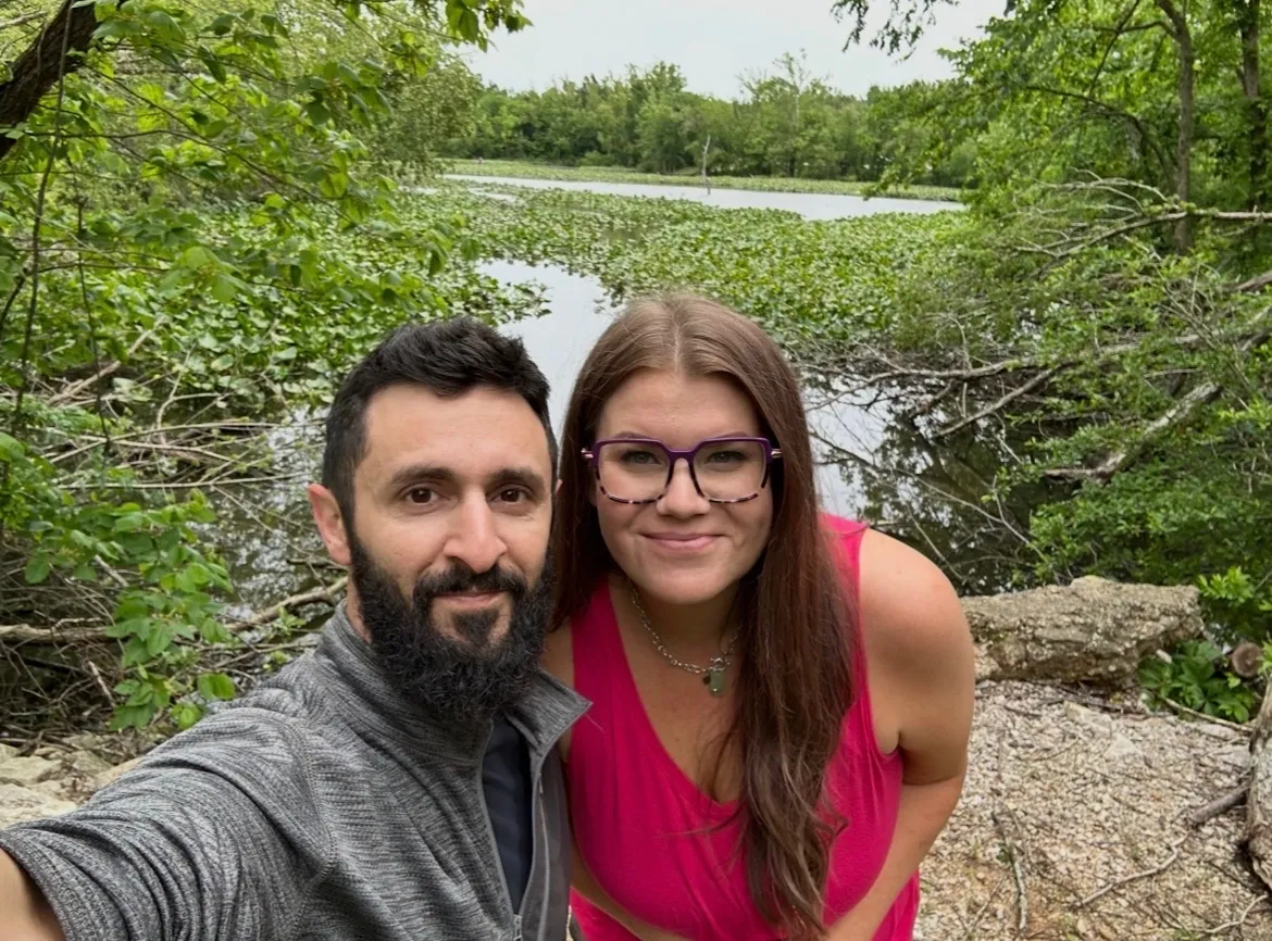 Lindsay Sutton and her husband on a hike near a lily-covered waterway