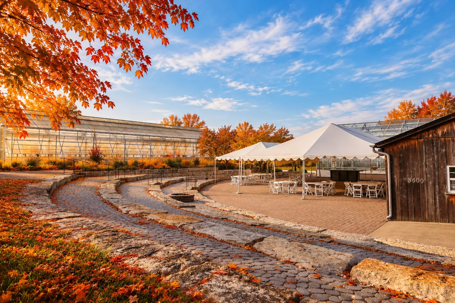 White event tents and seating on the stone-terraced patio at Shire Lane Estate in autumn