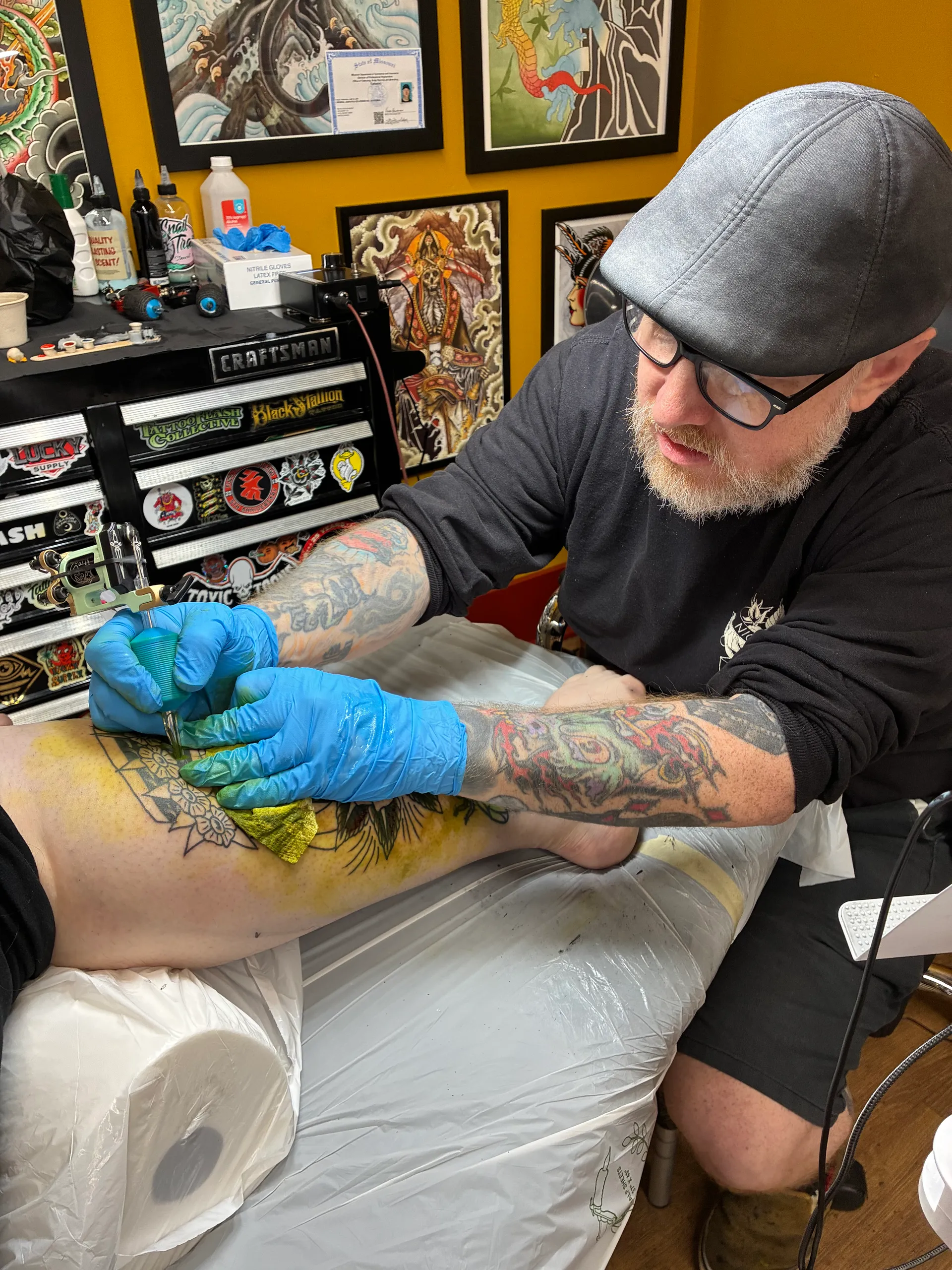 Derek Heidorn tattooing a client with a handmade machine at Frenchtown Tattoo Company