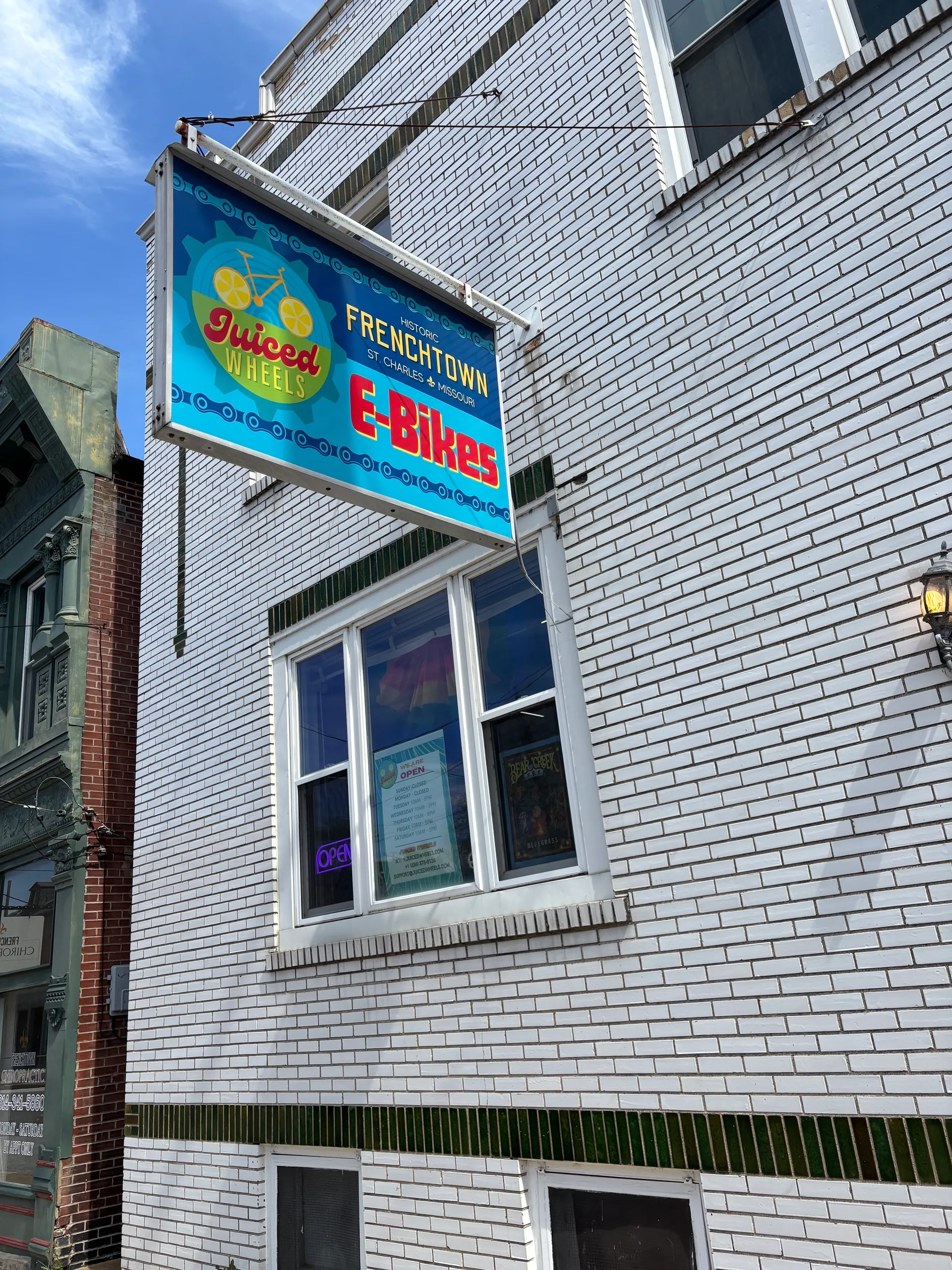 Juiced Wheels E-Bikes sign on the shop's building in historic Frenchtown, St. Charles