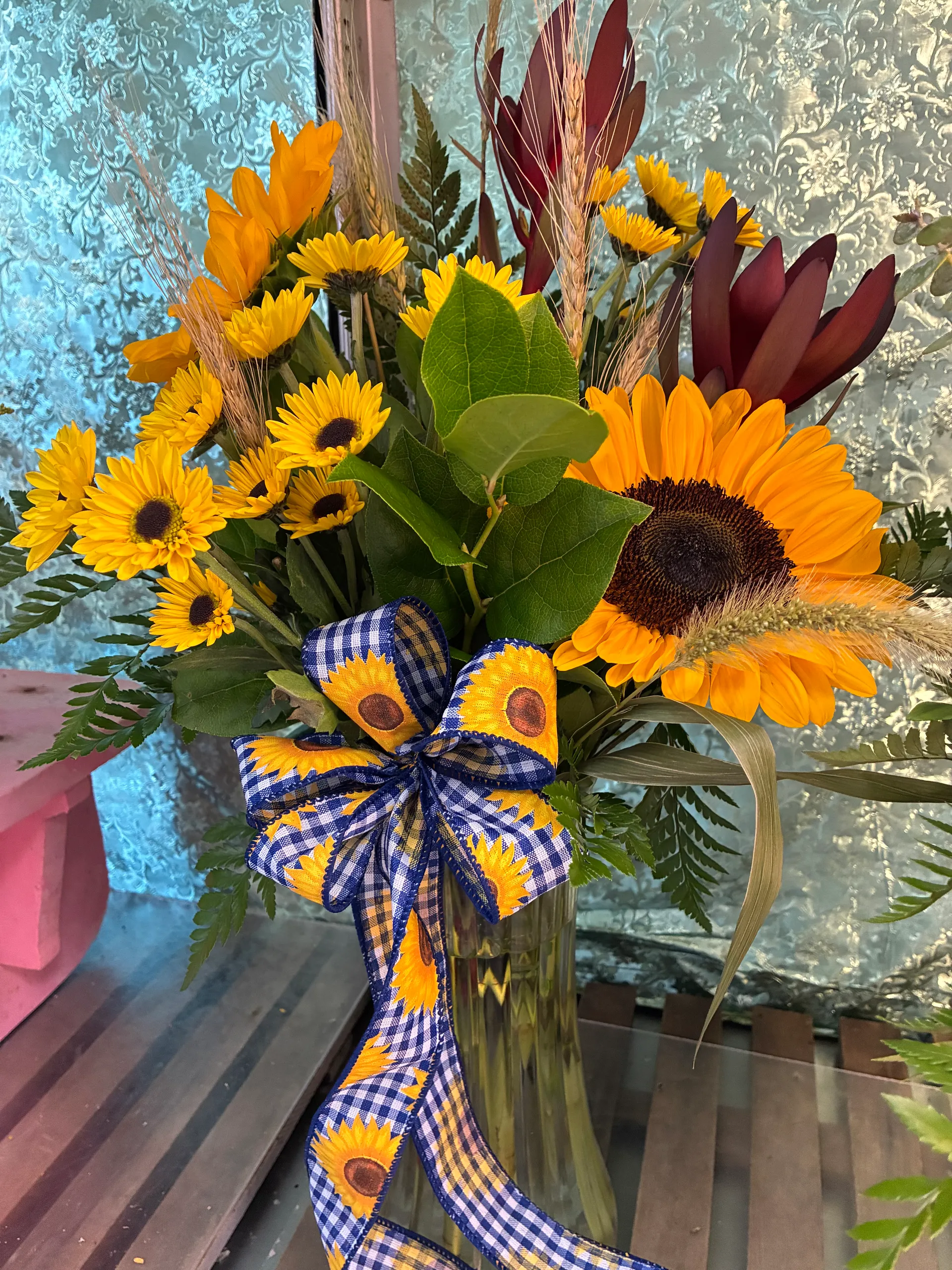 Fall sunflower arrangement with wheat and a gingham sunflower bow