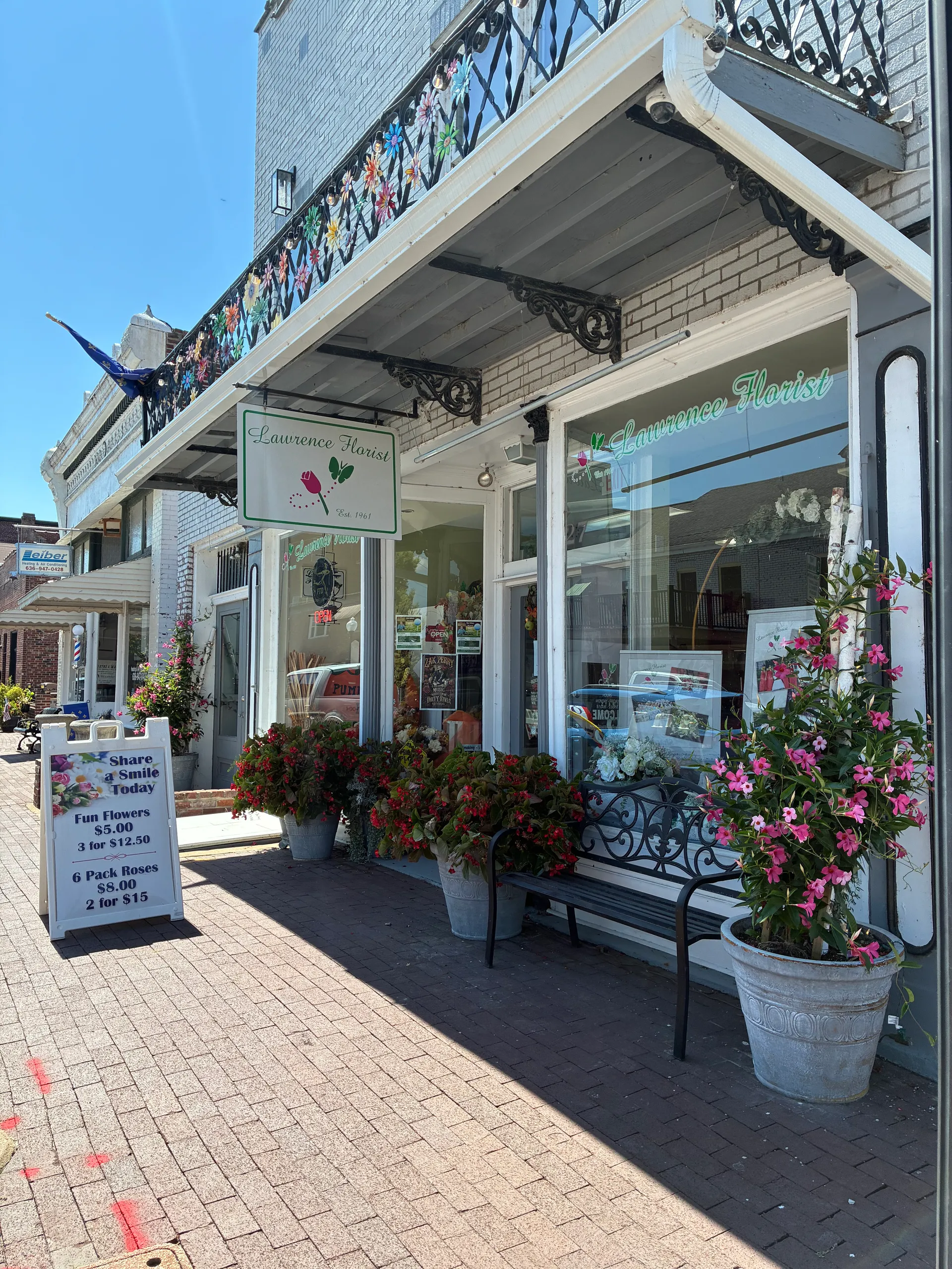 Lawrence Florist storefront at 927 North 2nd Street with flower pots and a sidewalk sign