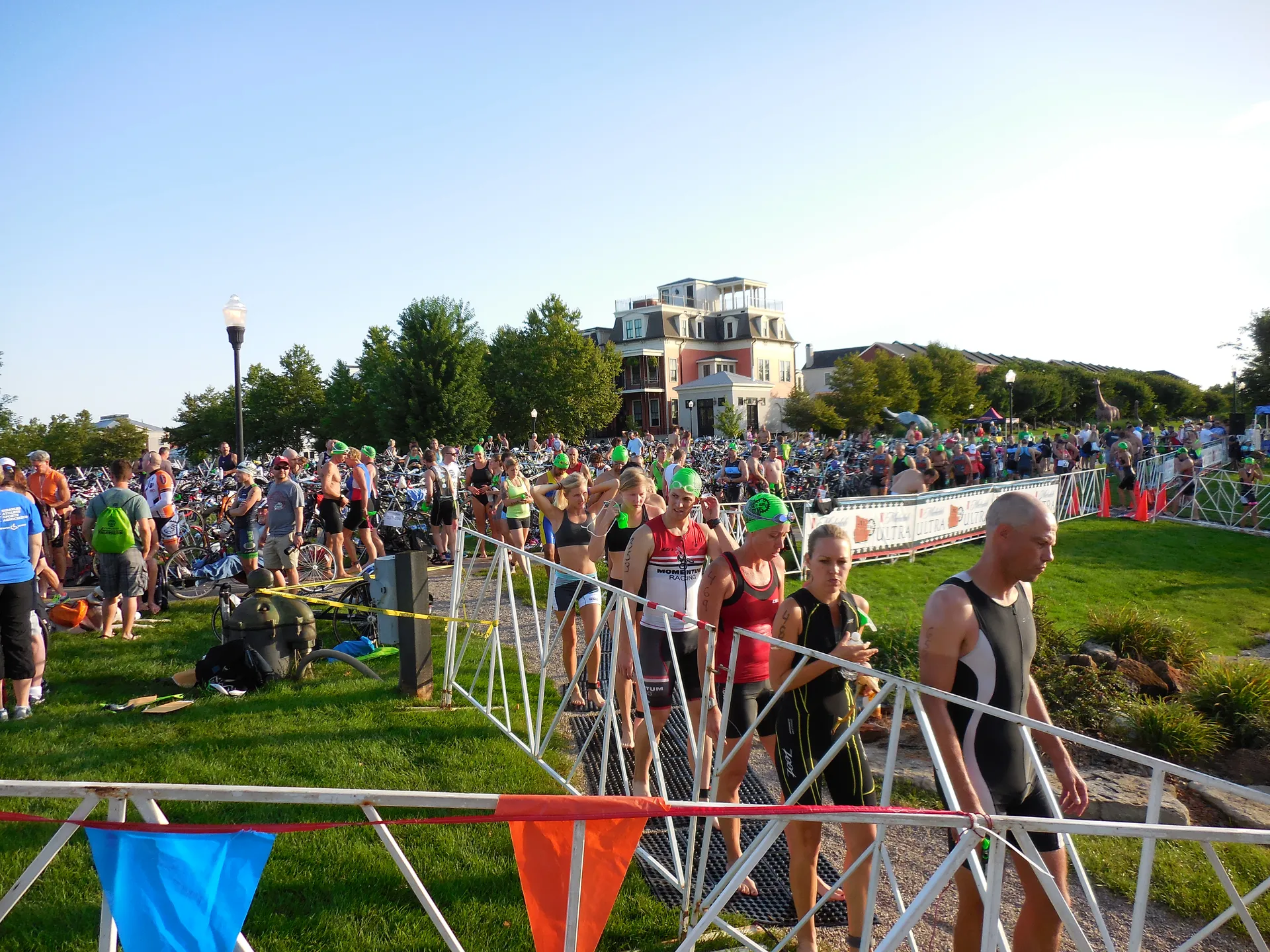 Triathletes in swim caps gather in the transition area at New Town during the Big Shark Triathlon