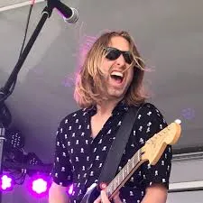 Clint Wilson playing guitar on stage