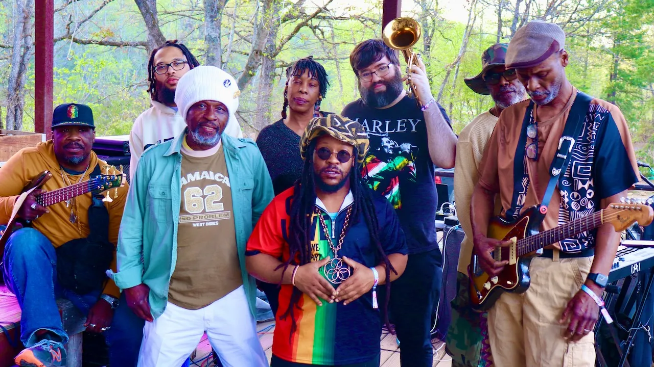 Members of the Non-Stop Reggae band gathered on an outdoor stage