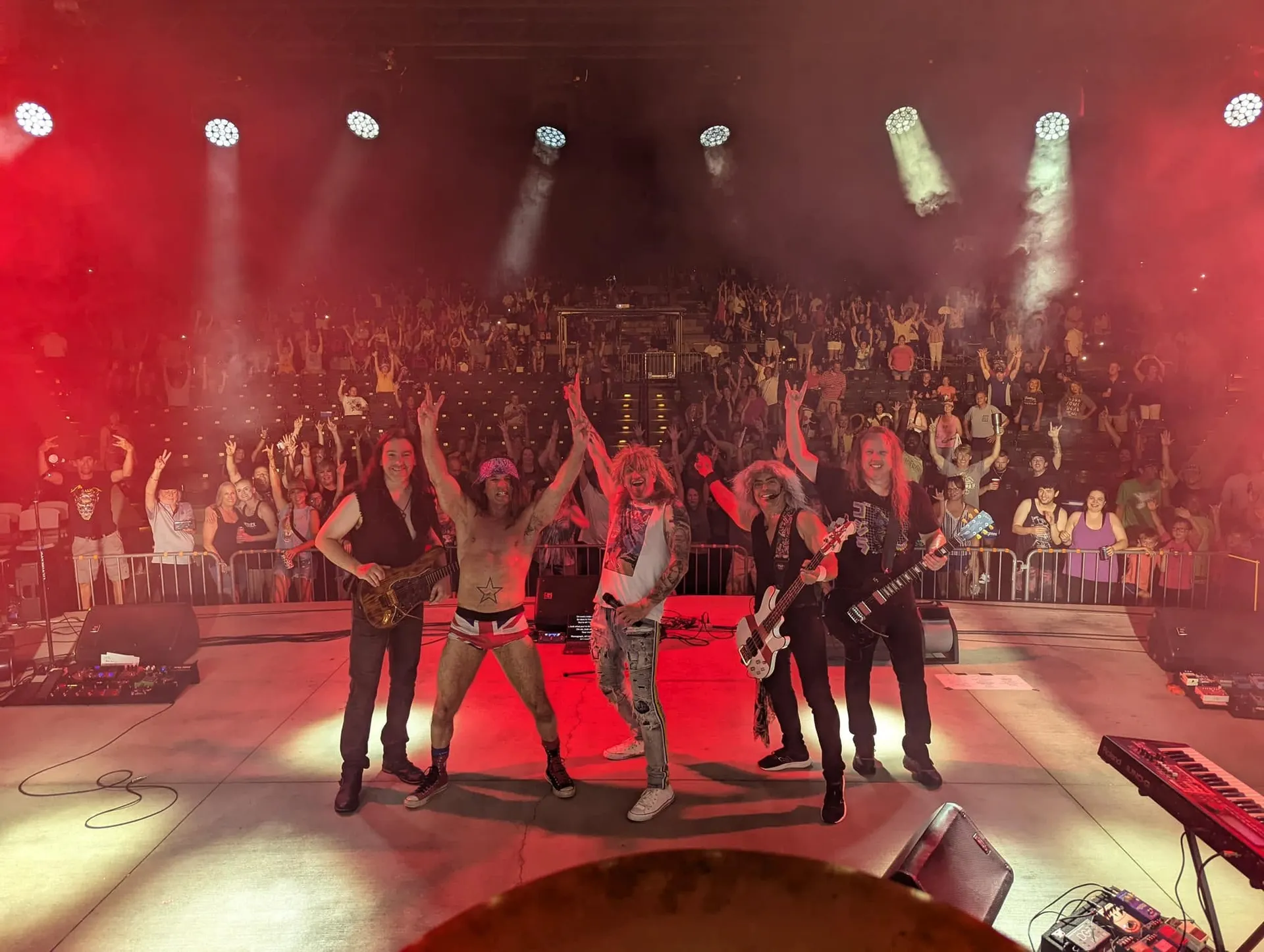 Pyromaniacs onstage in front of a cheering crowd at a live concert