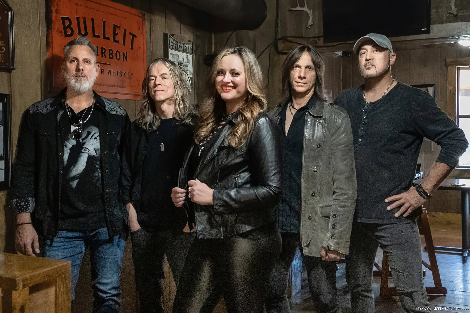 The five members of Real Rock Revival posing inside a rustic bar