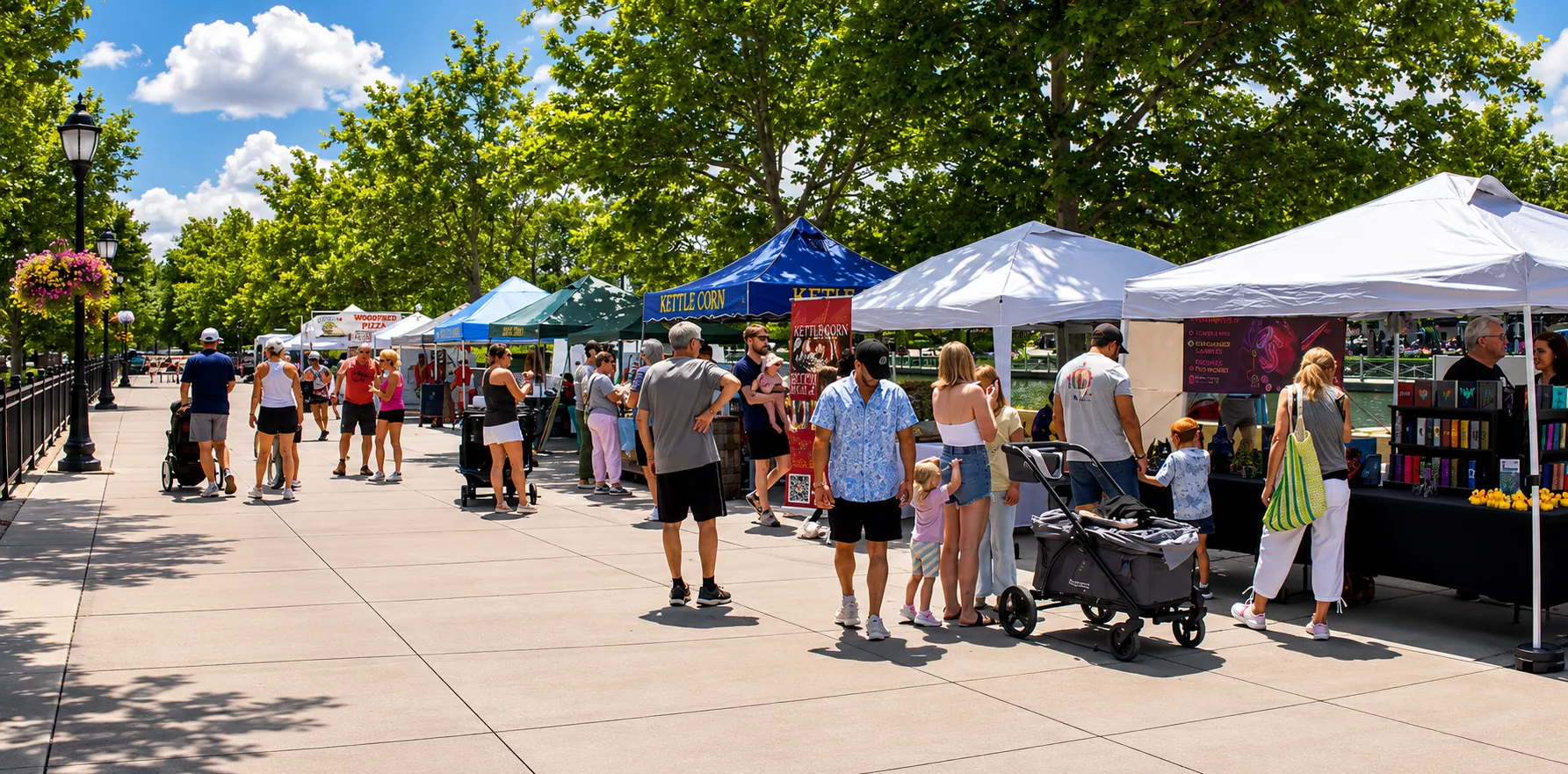 Shoppers browse vendor tents along the tree-lined promenade at the St. Charles Farmer's Market in New Town