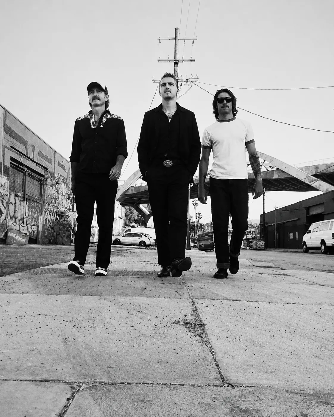 The Sea Monks — Jason, Noah, and Kai Kapchinske — walking down a city street